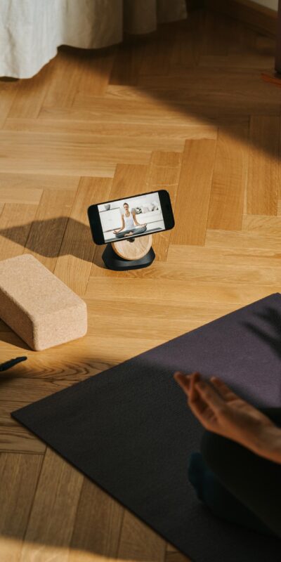 A serene home yoga setup with phone streaming class and mat.